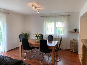 a dining room with a wooden table and chairs at Apartments Kivi in Novigrad Istria