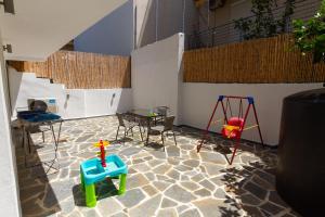 a room with play equipment and a table and chairs at The Minimal Apartments 3Floors in Loutra Edipsou
