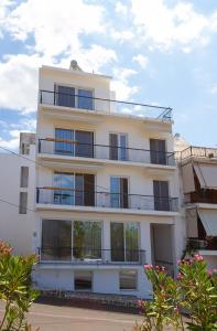 a white building with balconies on the side of it at The Minimal Apartments 3Floors in Loutra Edipsou