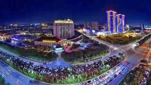 an aerial view of a city at night at Gladden Hotel Jiangmen in Jiangmen