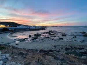 a view of the beach at sunset at Skye in Paternoster +4 photos