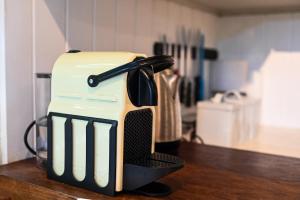 a toaster sitting on top of a wooden table at The Dogbox, Karen in Nairobi