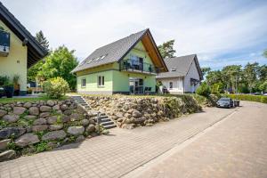 a house with a stone retaining wall and a driveway at Haus U13 in Röbel