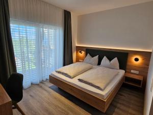 a bedroom with a bed and a large window at Packerhöhe in Pack