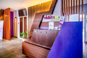 a wooden staircase in a room with a slide at SANS Vibes Violeta Inn Jambi in Jambi