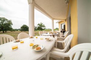 a white table and chairs with food on it at L'Horizon des Chênes - grand jardin, bbq & table de ping pong in Hagetmau