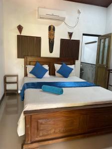 a bedroom with a bed with a mask on the wall at Angry birds rooms in Habarana +20 photos