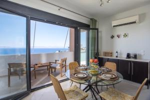 a kitchen and dining room with a table and chairs at Sea View Apartment in Rhodes Town