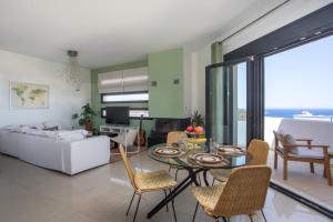 a living room with a table and chairs and a couch at Sea View Apartment in Rhodes Town