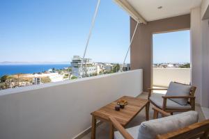 a balcony with a table and a view of the ocean at Sea View Apartment in Rhodes Town