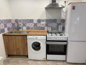 a kitchen with a washing machine and a sink at La Casa del Encinar in Valdemorillo