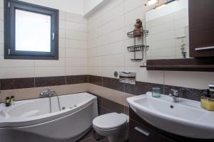 a bathroom with a tub and a toilet and a sink at Sea View Apartment in Rhodes Town +70 photos