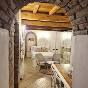 a bedroom with a bed and a table and chairs at Nell'antico ghetto ebraico in Ferrara