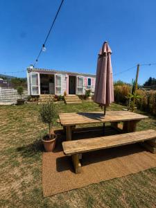 an umbrella sitting on a picnic table in a yard at La Finquilla Holidays in Estepona
