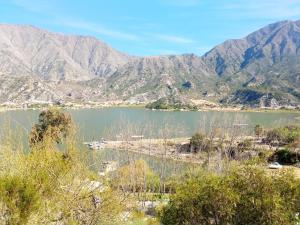 a view of a lake with mountains in the background at Cabañita La Paz Villa Sanagasta in Villa Bustos
