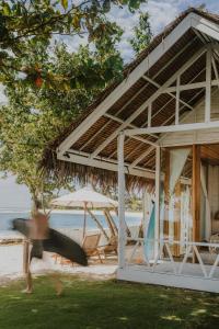 a person running in front of a house on the beach at La Belle Hollow Trees in Katiet