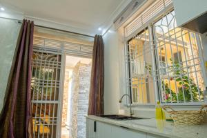 a kitchen with a sink and a window at E- Residence in Gulu +57 photos