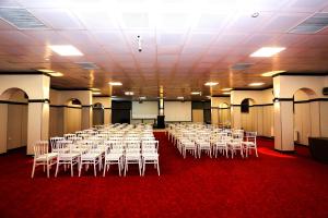 a room with rows of tables and white chairs at Family Resort Hotel in Selimpasa +72 photos
