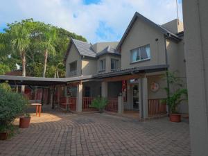 a house with a brick driveway in front of it at Lakeview Cabanas - Unit 11 in St Lucia