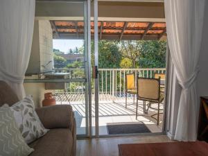 a living room with a sliding glass door to a patio at Lakeview Cabanas - Unit 11 in St Lucia