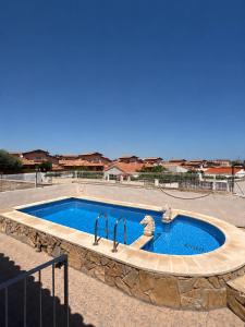 a swimming pool with two faucets in a yard at CASA Gayuba in Peniscola