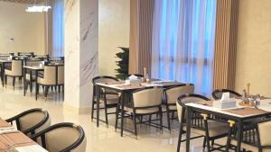 a row of tables and chairs in a restaurant at Transit Hotel in Juba
