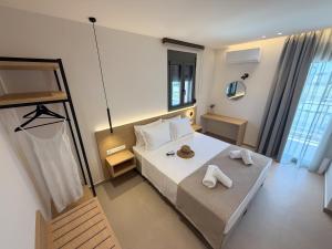 a bedroom with a bed with two towels on it at Elia Stay in Kalives Poligirou