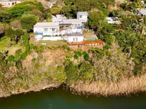 an aerial view of a house on an island in the water at Blues at Bonza Bay Beach in Beacon Bay