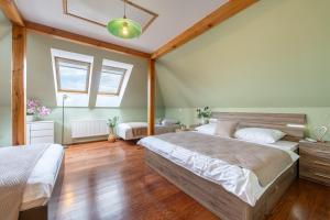 a bedroom with two beds and a window at Vila Fénix in Kutná Hora
