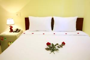 Rúm í herbergi á Danang Classic Hotel