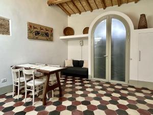 a living room with a table and chairs and a couch at Palazzo Ma.Ri.Lu. in Càbras