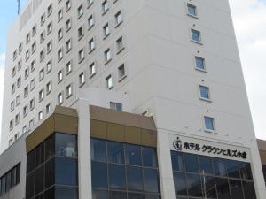 a building with a sign on the side of it at Hotel Crown Hills Kokura in Kitakyushu