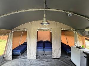a tent with blue pillows in the middle at Glamping in Style in Dronrijp