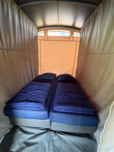 a small bed in the inside of a tent at Glamping in Style in Dronrijp