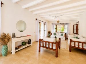 a living room with a couch and a table at Saffron Garden Malindi in Malindi +46 photos