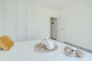 two towels on the floor in front of a mirror at Sandy Beach Complex in Perivolia +129 photos