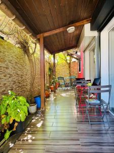 a patio with chairs and tables and a brick wall at Moya Résidence by MD in Dzaoudzi