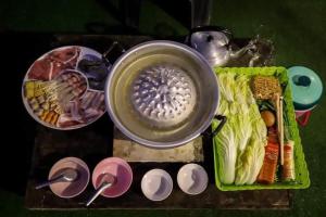 a table with a tray of food and a bowl of food at MonPhuView MonJam ม่อนภูวิว ม่อนแจ่ม in Mon Jam