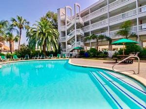 a large blue swimming pool in front of a building at Casa Del Mar Beach View in Galveston