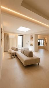 a large living room with two beds and a couch at Naim Boutique Hotel in Costa Rei