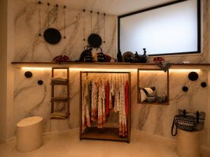 a dressing room with a mirror and a closet at Naim Boutique Hotel in Costa Rei +50 photos