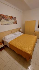 a bedroom with a large bed with a yellow blanket at Amelia Hotel in Momigno +29 photos