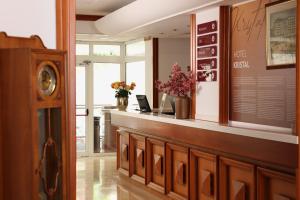 a restaurant with a counter with flowers on it at Hotel Kristal - by Liburnia Hotels & Villas in Opatija