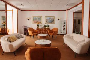 a living room with couches and chairs and a table at Hotel Kristal - by Liburnia Hotels & Villas in Opatija