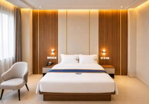 a bedroom with a large bed and a chair at Transit Hotel in Juba