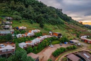 an aerial view of a village on a hill at MonPhuView MonJam ม่อนภูวิว ม่อนแจ่ม in Mon Jam