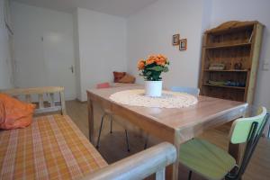 a dining room table with a vase of flowers on it at Haus im Ländle in Volkertshausen +8 photos