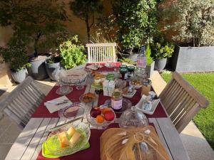 a picnic table with plates of food on it at La Maison de Marie in Blaye