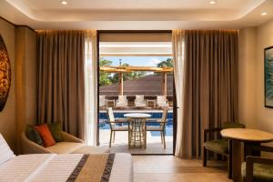 a hotel room with a bed and a view of a patio at Coron Westown Resort in Coron +66 photos