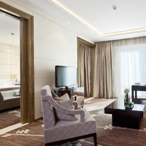 a living room with a chair and a television at The Jade Boutique Hotel in Wuhan
